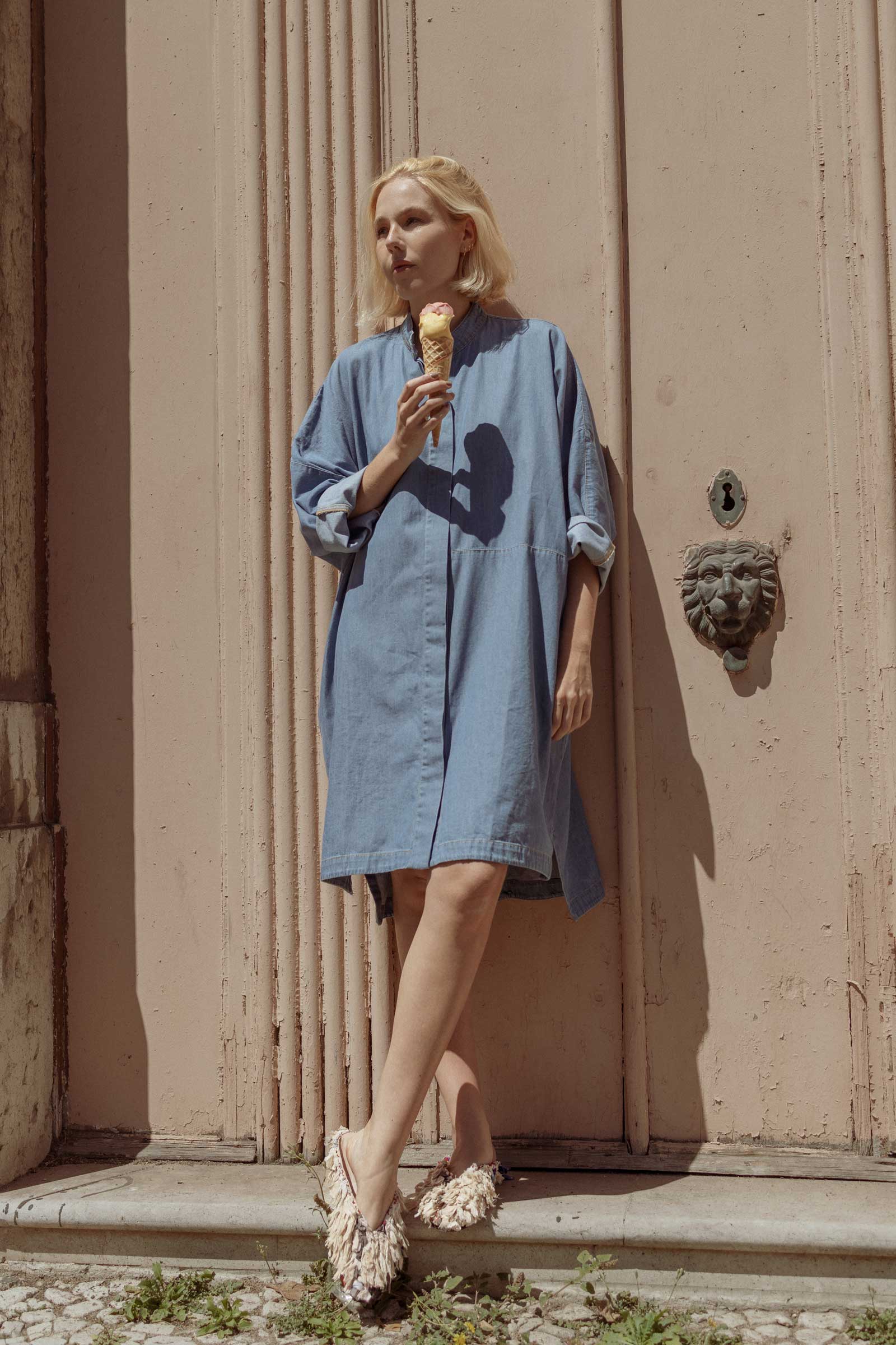 Model having ice cream and wearing a 10 to 10 denim shirt dress
