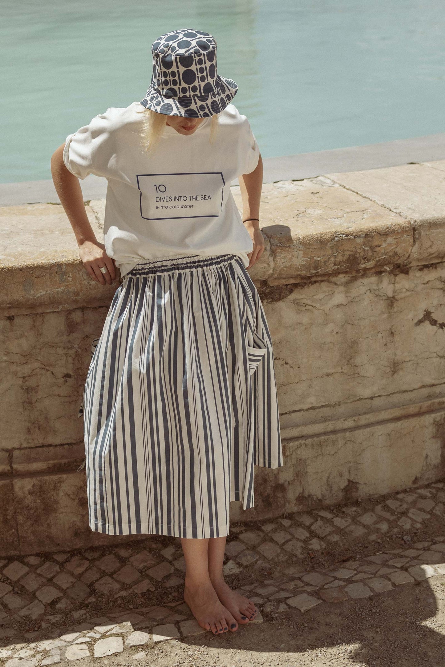 Model wearing 10 to 10  striped white and blue skirt