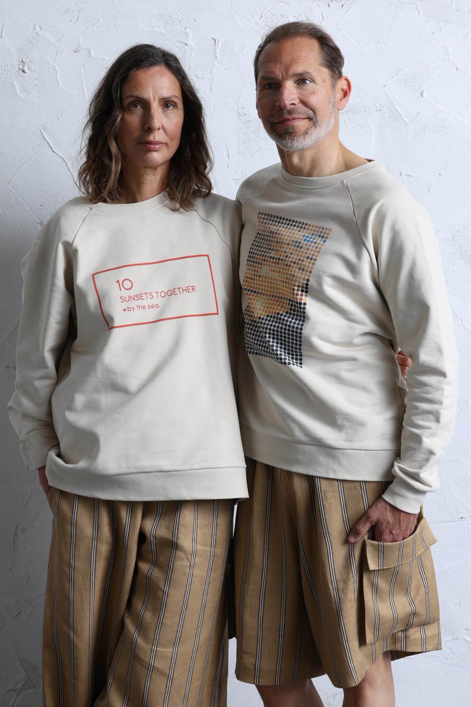 Couple wearing 10 to 10 Unisex sweatshirt with Dots print and quote representing a sunset by the sea